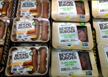 Packages of Beyond Burgers and Beyond Sausages in a supermarket case.