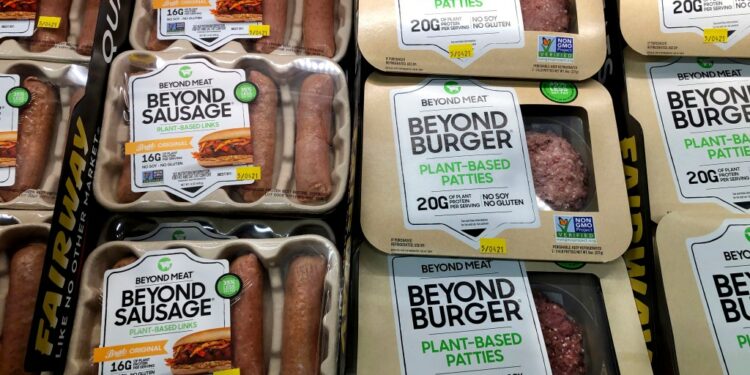 Packages of Beyond Burgers and Beyond Sausages in a supermarket case.
