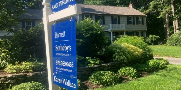 A sign noting a pending sale is shown in front of a home in Conrod, Mass.