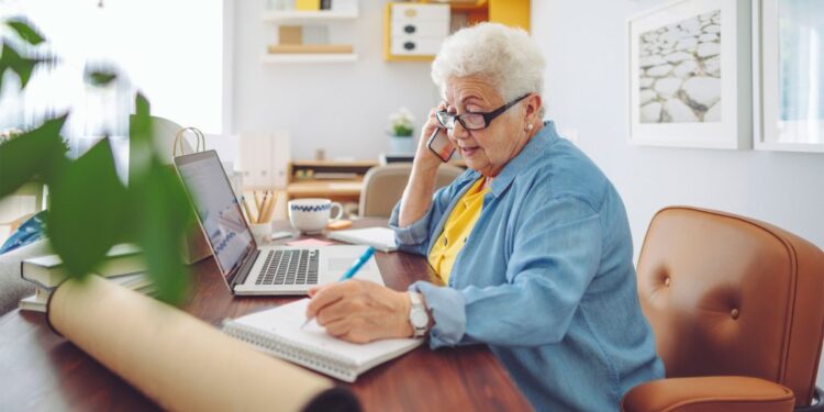 Old woman working on a computer.