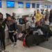 Travelers await at the departure counter at the United Airlines terminal at Los Angeles International Airport.