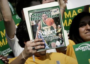A George Mason University fan holds up a Sports Illustrated magazine at a send off for the team, March 29, 2006, in Fairfax, Va