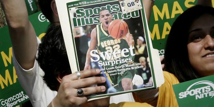 A George Mason University fan holds up a Sports Illustrated magazine at a send off for the team, March 29, 2006, in Fairfax, Va