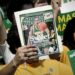 A George Mason University fan holds up a Sports Illustrated magazine at a send off for the team, March 29, 2006, in Fairfax, Va