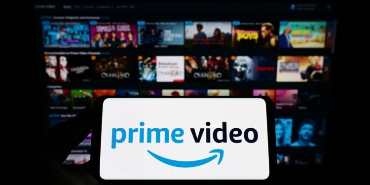 Person holding smartphone showing Amazon Prime Video app on screen.