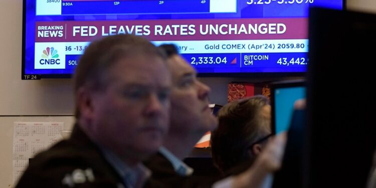 A television screen on the floor of the New York Stock Exchange displays the Federal Reserve's decision on interest rates, Jan. 31, 2024.