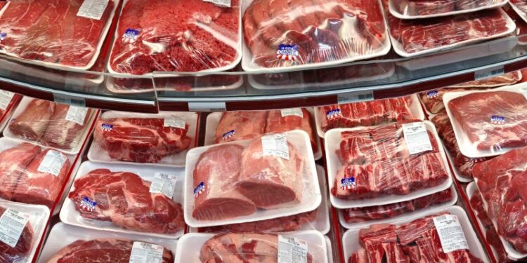 Various cuts of beef and pork in plastic wrap on a shelf at a discount market in Arlington, VA.