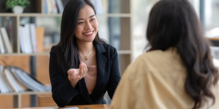 Two happy asian businesswoman talking and consulting working together in the office.