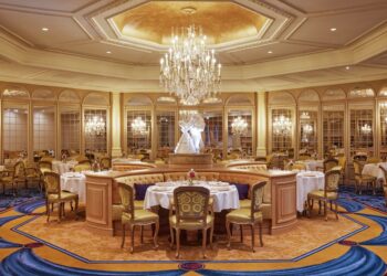 Tables and chairs in a room at Disneyland Paris's newly-refurbished five-star Disneyland Hotel, following a two-year renovation.