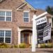 A 'For Sale' sign posted outside a house in Acworth, Georgia, relating to property tax legislation in 2024