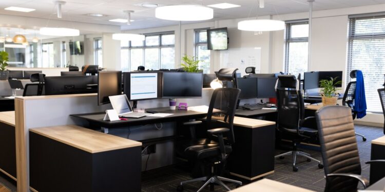 Open office space with desks, chairs, and computers