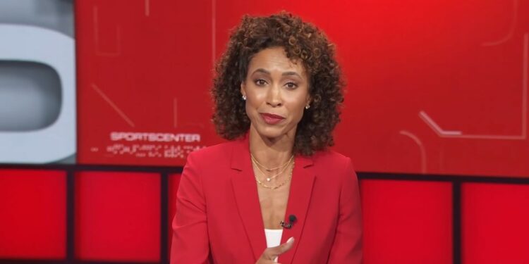 Sage Steele, former ESPN host, in a red suit discussing her structured interview with President Joe Biden