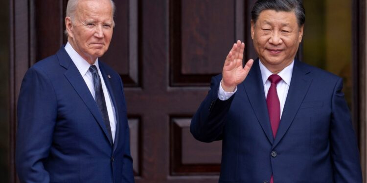 President Joe Biden and China's President Xi Jinping waving in suits during their meeting in Woodside, Calif on Nov, 15, 2023