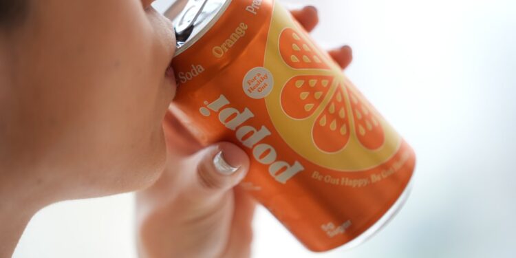 A person drinks Poppi, a prebiotic soda, on Wednesday, April 10, 2024, in New York.