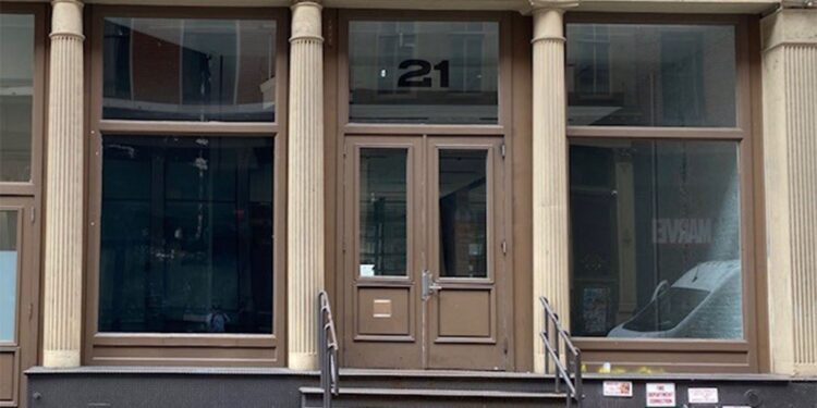 A building with a door and windows at 21 Mercer St. in Soho