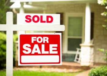 A for sale sign in front of a house