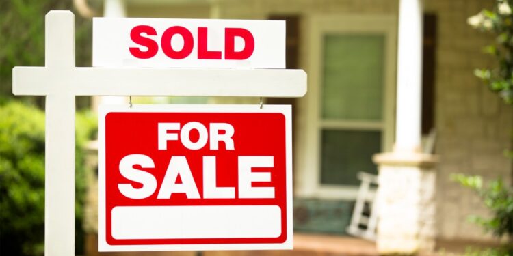 A for sale sign in front of a house