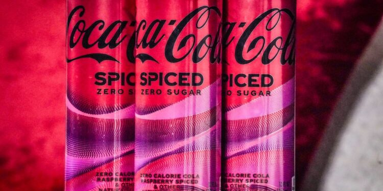 Cans of Coca-Cola Spiced being unveiled at a livestream media event in New York on February 6, 2024