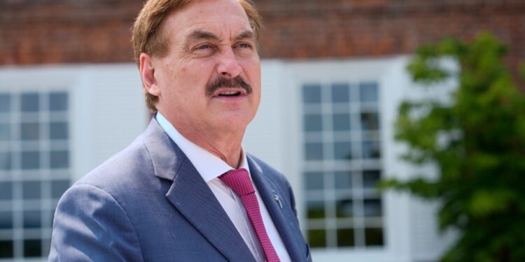 Mike Lindell, CEO of MyPillow, talks before Republican presidential nominee former President Donald Trump speaks at a news conference.