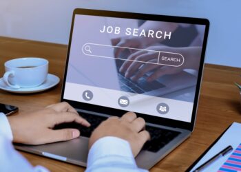 Woman using laptop, searching for a job online