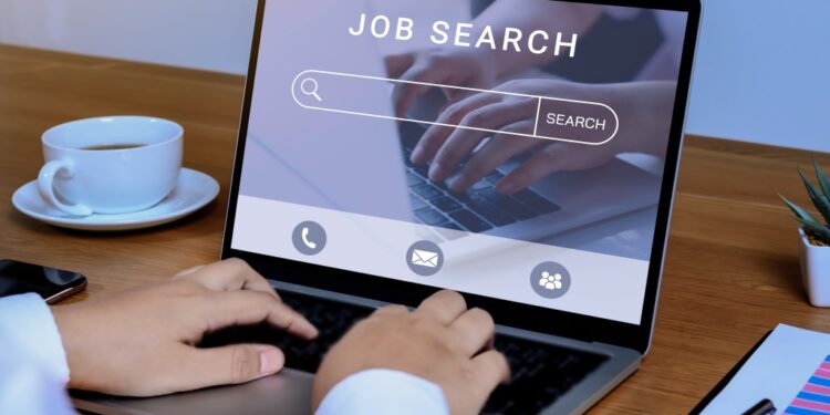 Woman using laptop, searching for a job online