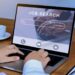 Woman using laptop, searching for a job online