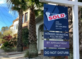 Sold sign in front of home