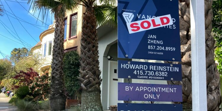 Sold sign in front of home