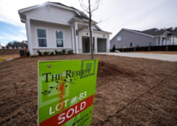 Sold sign in front of home.