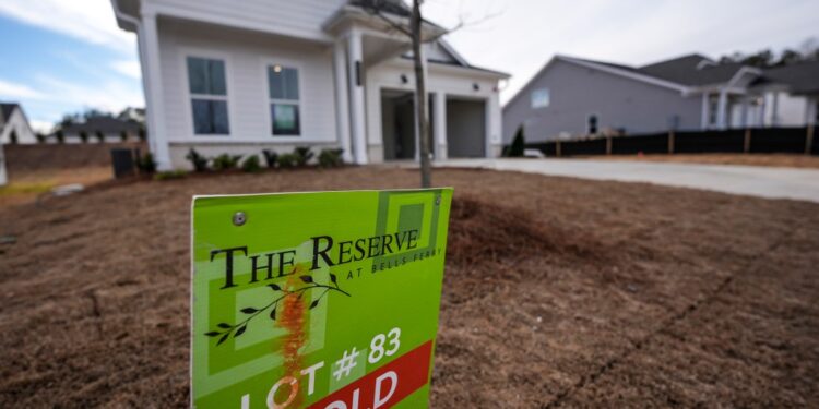 Sold sign in front of home.