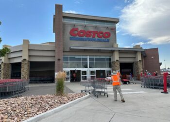 Cart wrangler gathering shopping carts outside Costco.