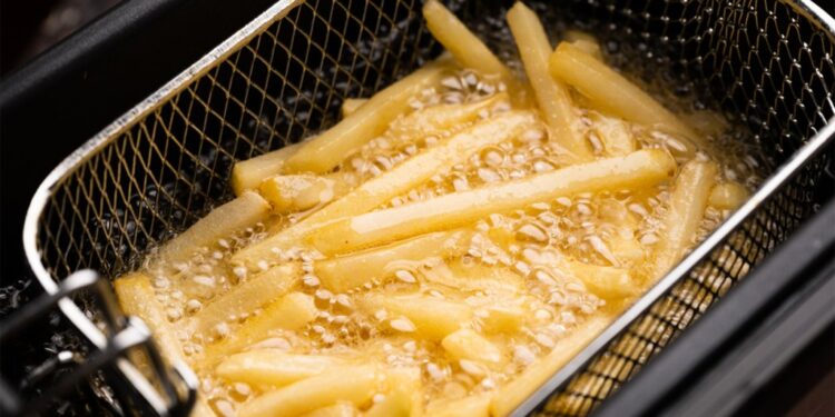 French fries cooking in a deep fryer