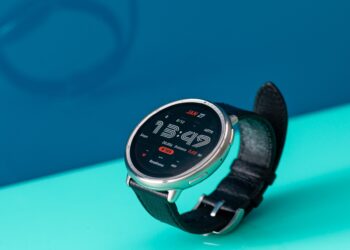 Angled view of the Amazfit Active 2 showing a stylish retro watch face against a bright blue background