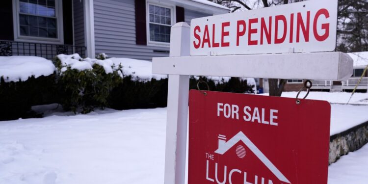 Sale pending sign in front of home