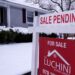 Sale pending sign in front of home
