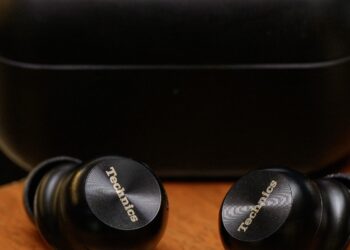 A hands-on photo of the Technics AZ100 earbuds.