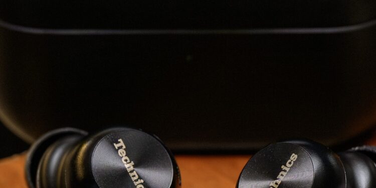A hands-on photo of the Technics AZ100 earbuds.