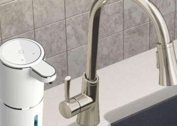 Soap dispenser next to faucet.