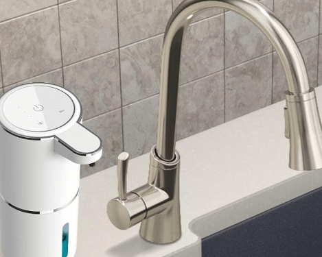 Soap dispenser next to faucet.