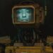 A humanoid robot with a monitor for a head displaying an actual human face.
