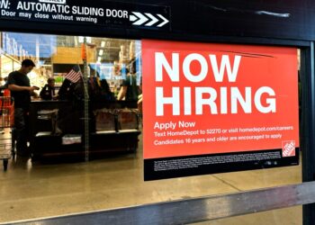 Hiring sign displayed at a retail store in Mount Prospect, Illinois.