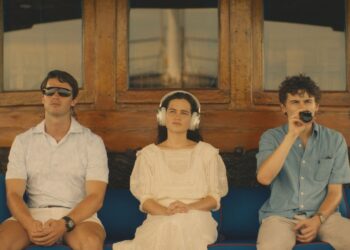 Shawn Mendes, Patrick Schwarzenegger, and Laura Närhi sitting on a bench smoking in a setting titled 'White Lotus'