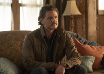 Pedro Pascal sitting on a couch
