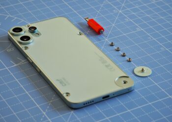 The CMF Phone 2 Pro with its screws next to it