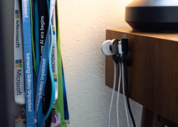 side of desk with several cords hanging from the side