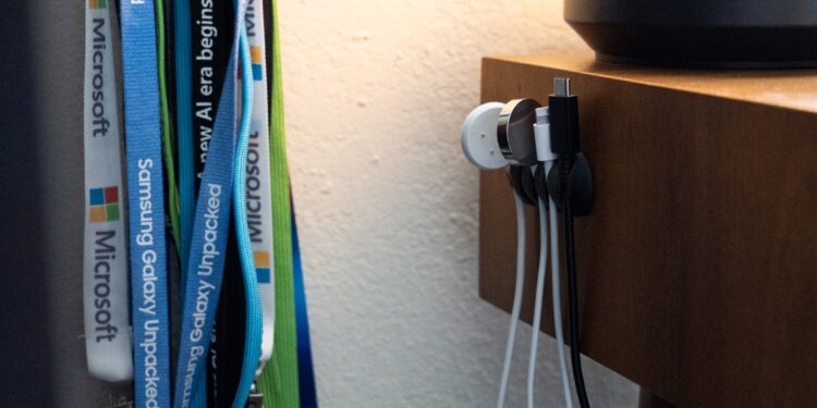 side of desk with several cords hanging from the side