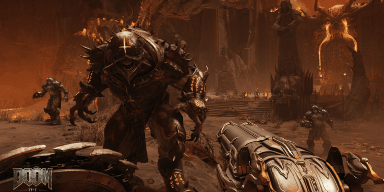 Screenshot from Doom The Dark Ages featuring the perspective of the slayer facing down a demon holding the super shotgun.