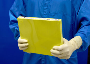 An employee holds a full-size prototype LMR battery cell at the General Motors Wallace Battery Cell Innovation Center.