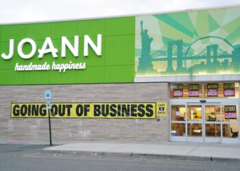 A general view of a Joann Fabrics store with a "going out of business" sign.