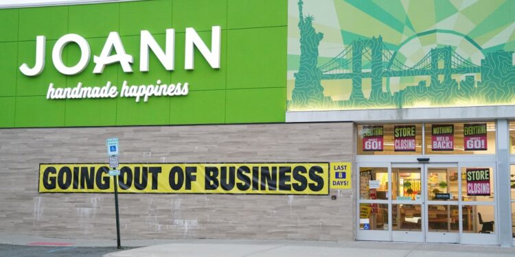 A general view of a Joann Fabrics store with a "going out of business" sign.